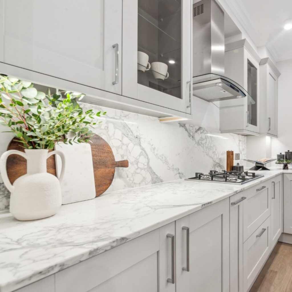 Grey kitchen cabinetry and marble-effect splashback in a refurbished Pimlico home