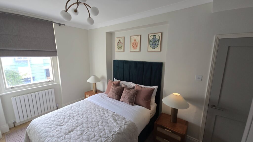 Completed bedroom with teal headboard in a one-bedroom Paddington W2 rental flat